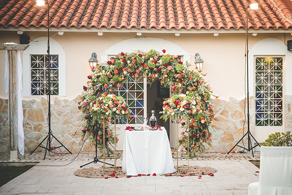 Μοντέρνος στολισμός τελετής γάμου με αψίδα λουλουδιών και χρυσές ανθοστήλες