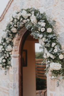 Διακόσμηση εισόδου εκκλησίας με γιρλάντα λουλουδιών