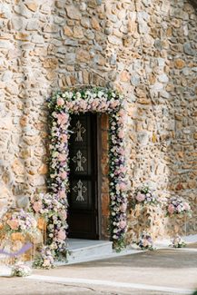 Ρομαντικός στολισμός εισόδου εκκλησίας λιλά και peach λουλούδια